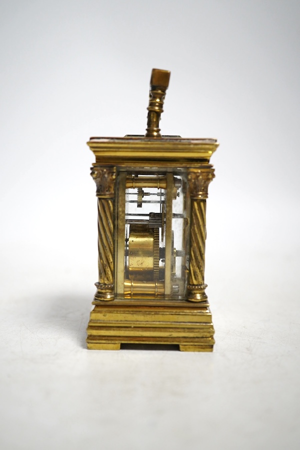 A miniature carriage timepiece, with four ornate corner columns, turquoise dial and gilt filigree mount, 8cm high. Condition - fair, not tested as working